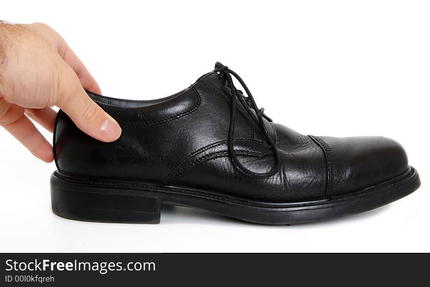 A dress shoe isolated on white with hand; clipping path. A dress shoe isolated on white with hand; clipping path.