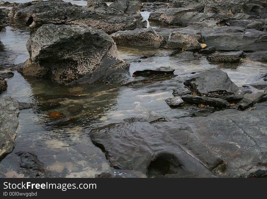 Water rushing through the rocks on the beach. Water rushing through the rocks on the beach