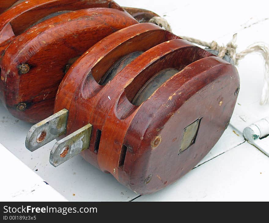 Pulley for sails and ropes made from wood on an old sail boat. Pulley for sails and ropes made from wood on an old sail boat