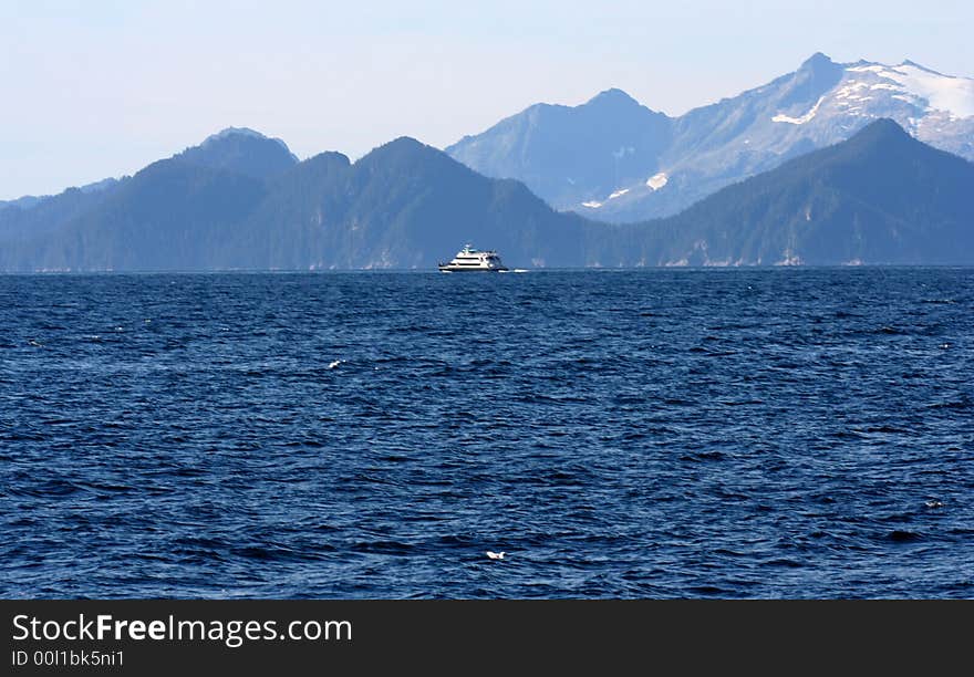 Bright blue water highlights the majestic mountians in the background. Bright blue water highlights the majestic mountians in the background.