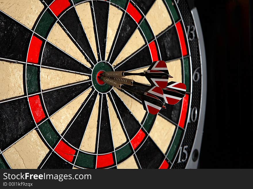 Darts in Bullseye on a dartboard. Darts in Bullseye on a dartboard