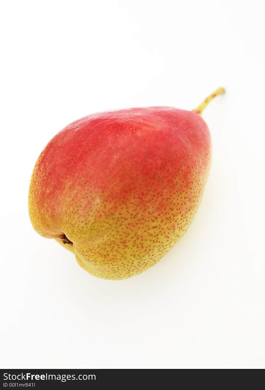 A single ripe English pear against a white background. A single ripe English pear against a white background