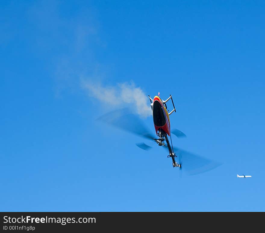 An model helicopter flying upside down. An model helicopter flying upside down