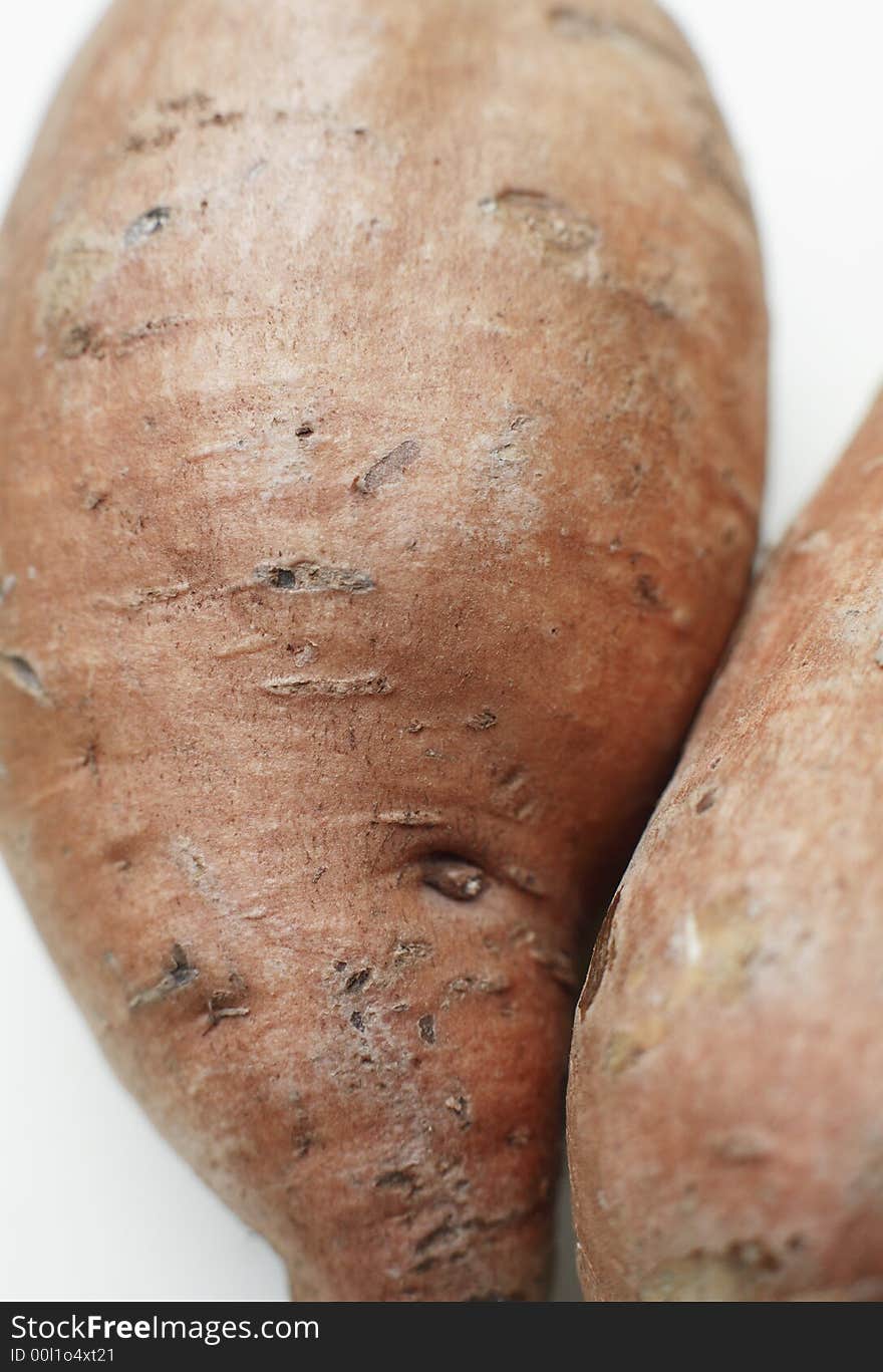 Organic Sweet potato against a white background