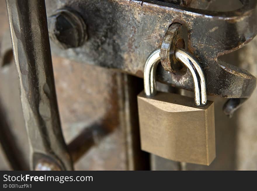 Padlock on a rusty metal door