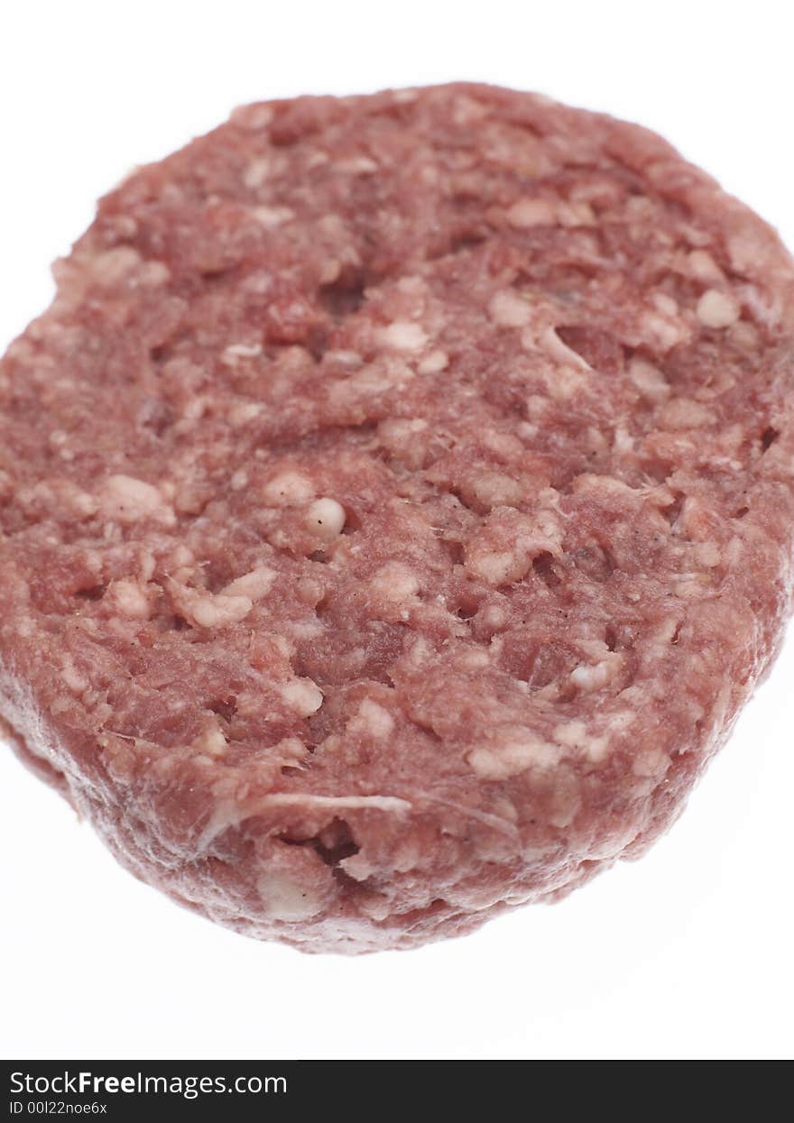 Uncooked raw Beefburger against a white background