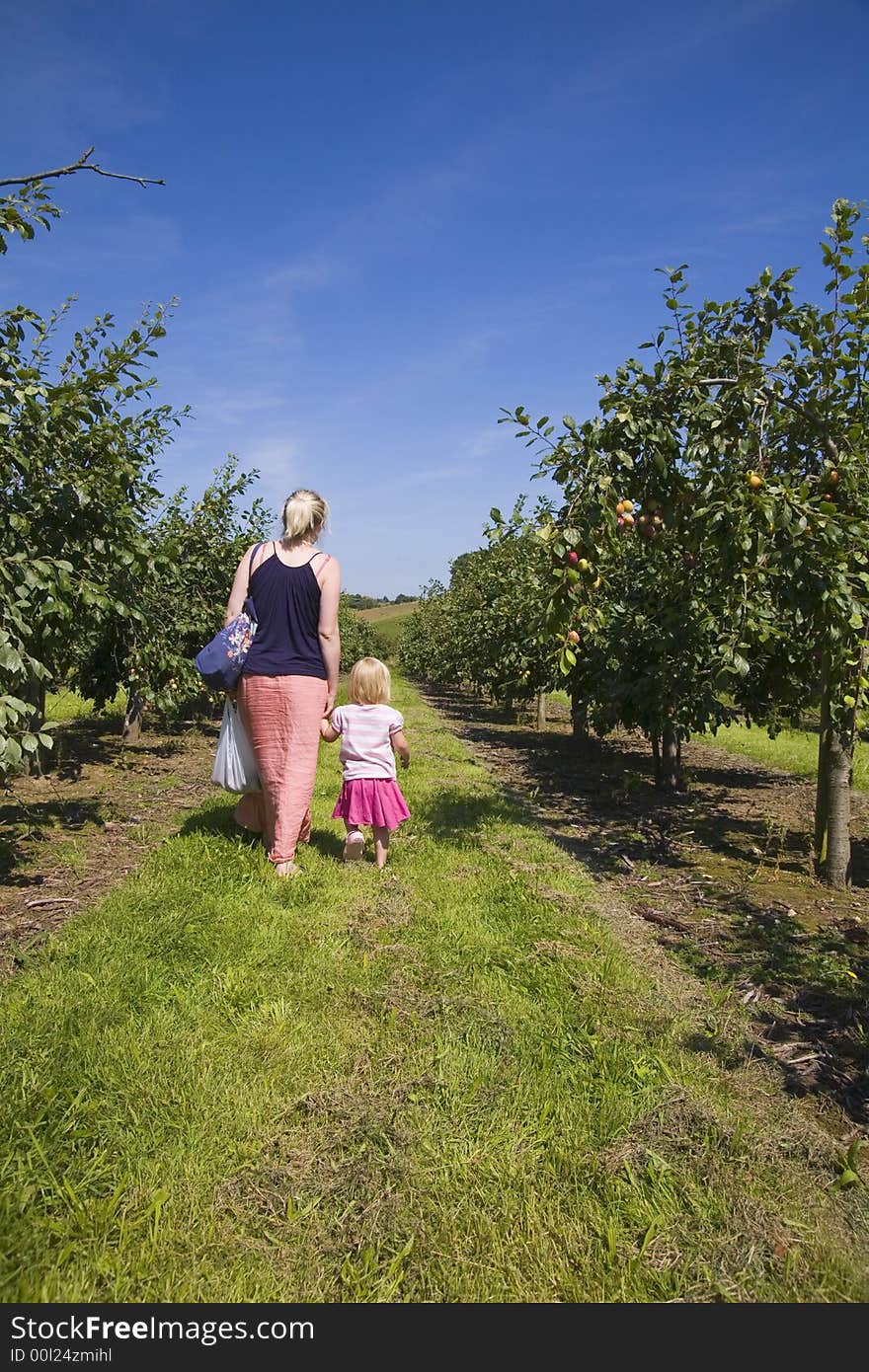 Mother And Daughter In Orchard