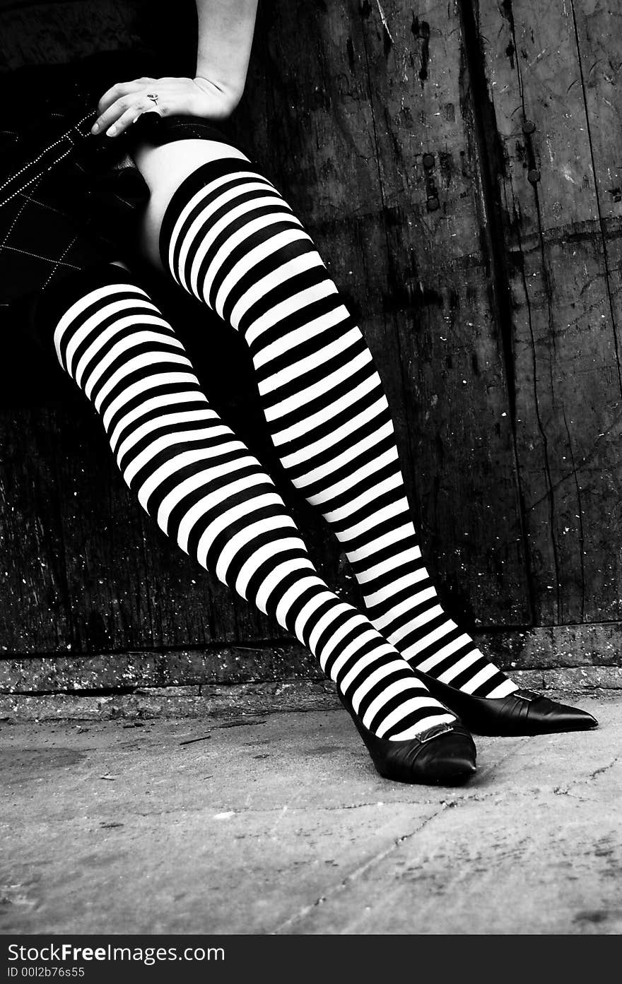 Womans legs with striped stockings in heels. Womans legs with striped stockings in heels