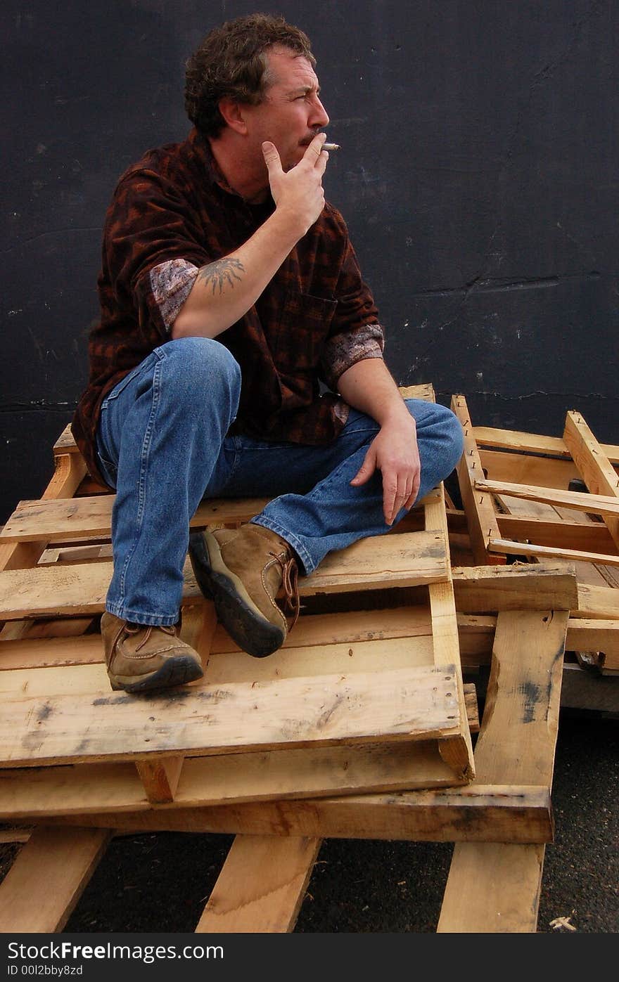 Smoking Man On Wood Pallets