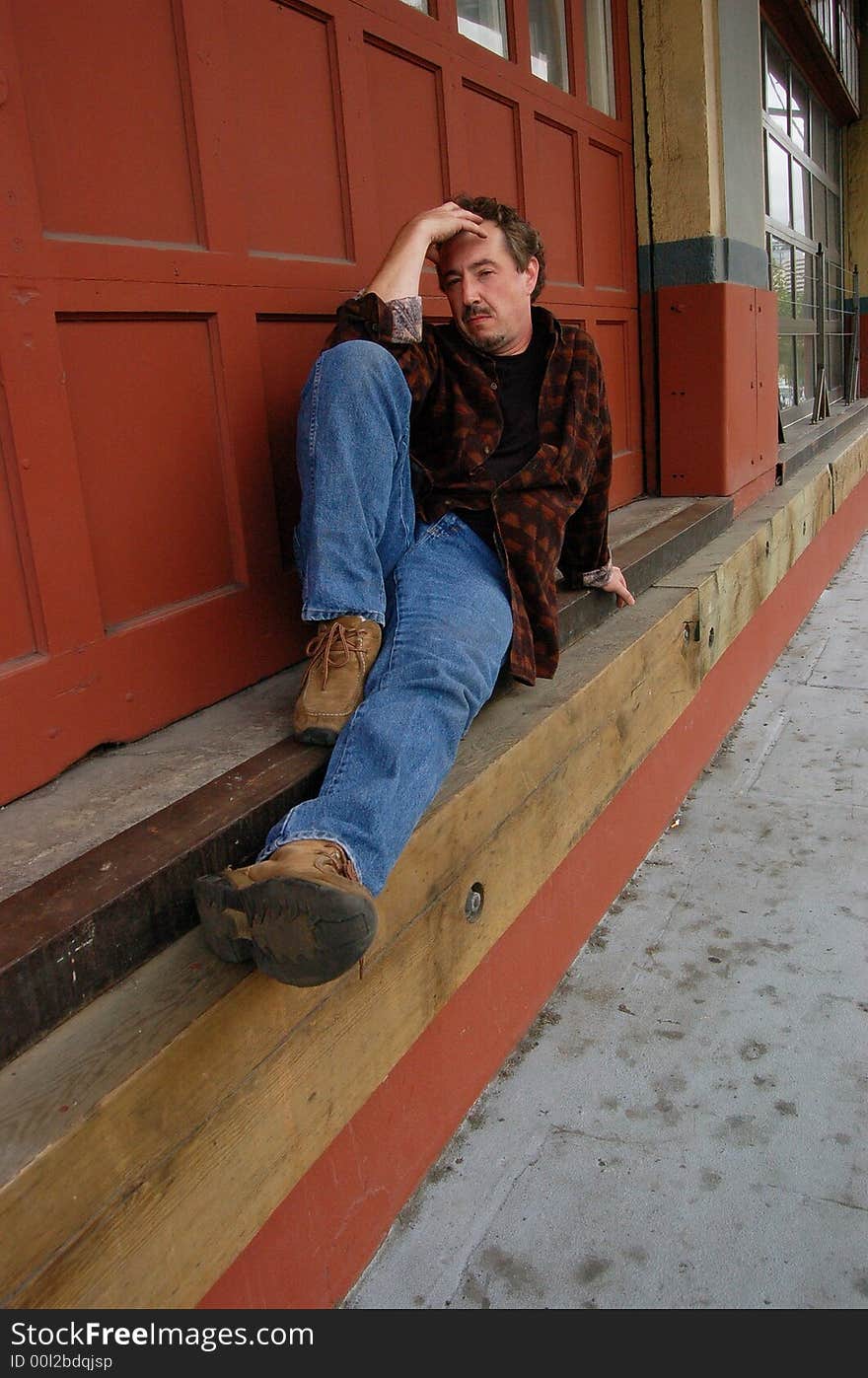 Middle-aged man resting in the city. Middle-aged man resting in the city