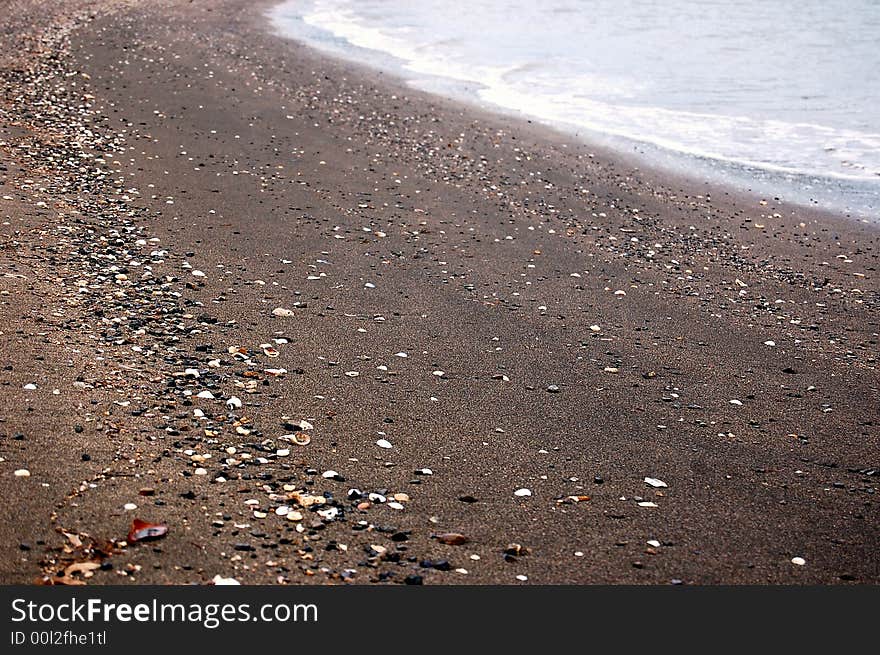 Beach of black sand on the west coast of new caledonia