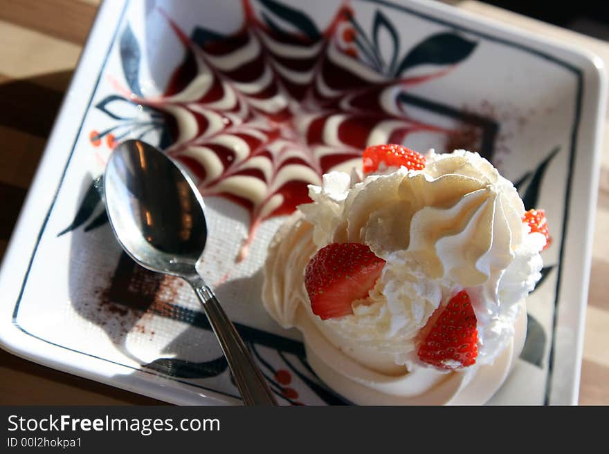 Dessert with whipped cream and a strawberry