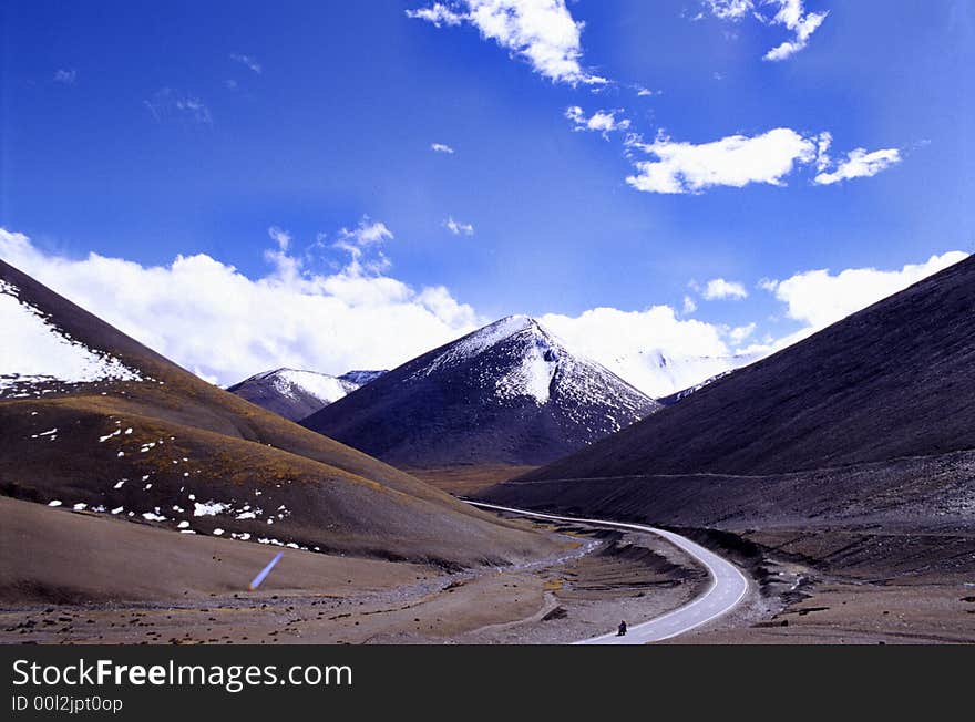 The road in the jokuls, white snow is so close to you. it is a difficult road for human. because it is 4,000 m height above sea level. it is not easy to meet person in this road. by the way, it is good for hiker. the location is in Tibet of China. (use Koda positive film E100vs) See more my images at :). The road in the jokuls, white snow is so close to you. it is a difficult road for human. because it is 4,000 m height above sea level. it is not easy to meet person in this road. by the way, it is good for hiker. the location is in Tibet of China. (use Koda positive film E100vs) See more my images at :)