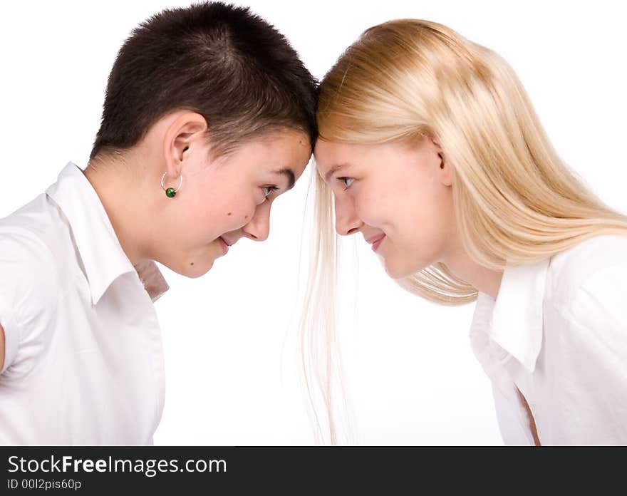 Close-cut brunette and long-haired blond stand face to face. Close-cut brunette and long-haired blond stand face to face