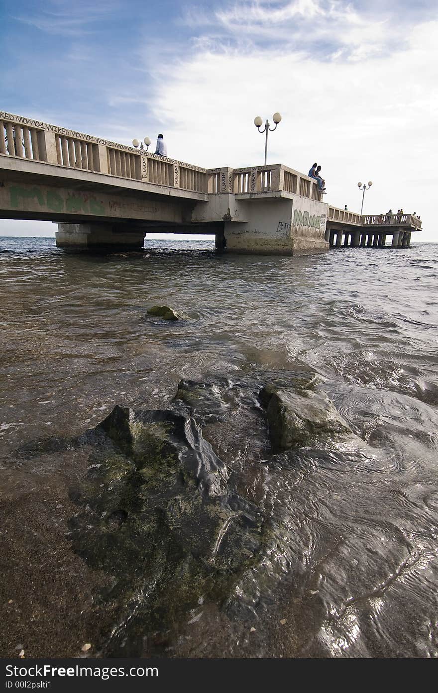 Black stones with landing stage in the background