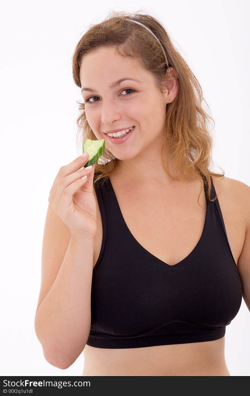 Fitness girl hold an slice of cucumber. Fitness girl hold an slice of cucumber