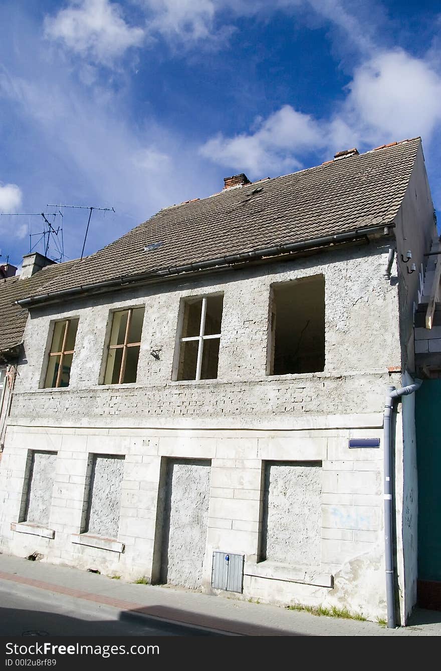 A house with its door and windows filled with concrete, abandoned. A house with its door and windows filled with concrete, abandoned.