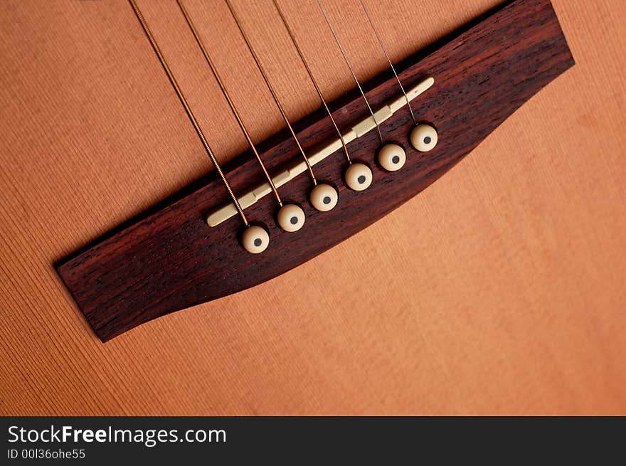 Closeup details of an acoustic wooden guitar