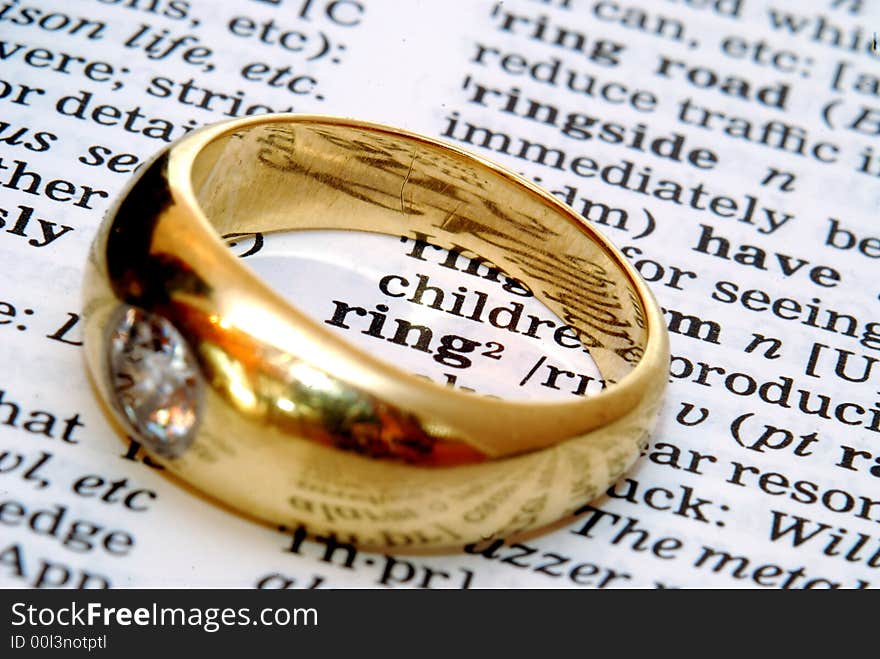 The word ring out of a dictionary with a gold ring next to it. The word ring out of a dictionary with a gold ring next to it