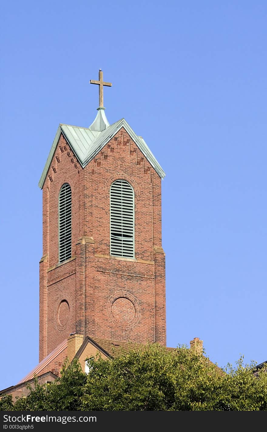 A church tower with a blue sky background. A church tower with a blue sky background