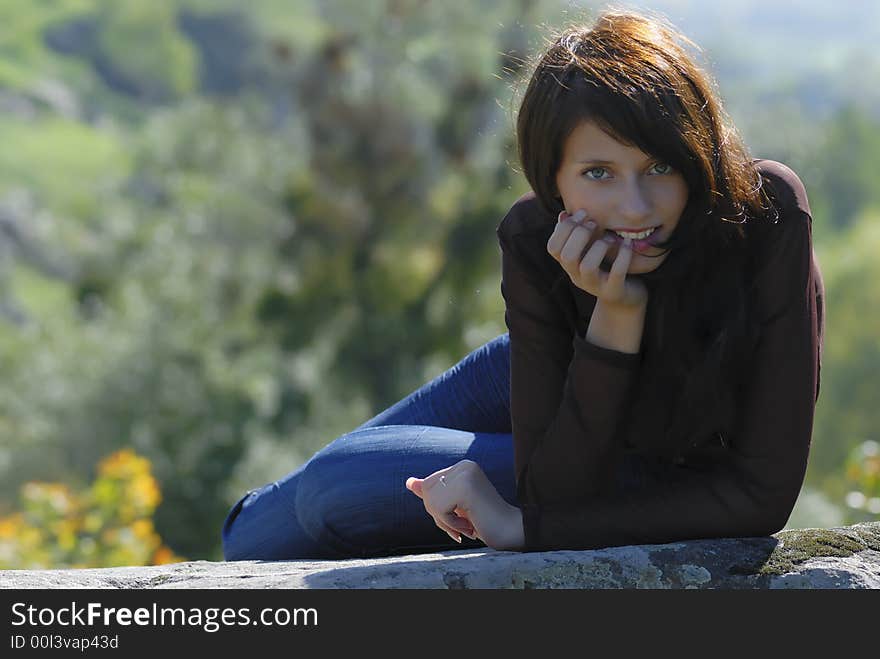 Smiling girl on a rock. Smiling girl on a rock