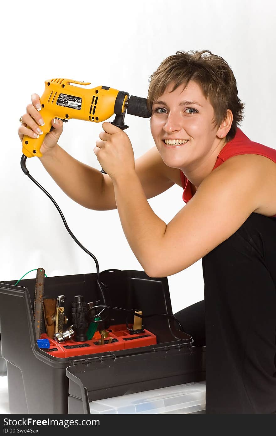 Portrait of young brunette holding the drill. Portrait of young brunette holding the drill