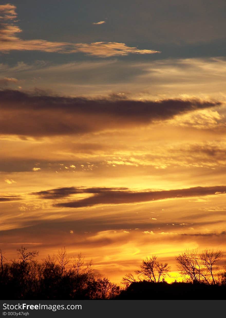 An orange sunset casting over a blue sky. An orange sunset casting over a blue sky.