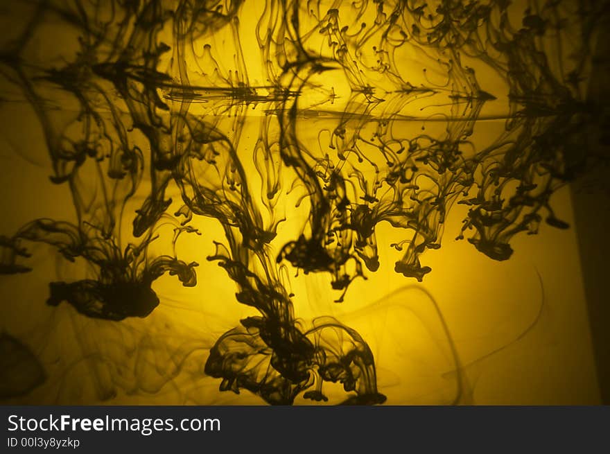 Ink polluting the water. Image in yellow colors. Ink polluting the water. Image in yellow colors