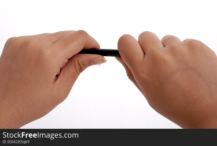 Hands trying to break a pencil over a white background. Hands trying to break a pencil over a white background