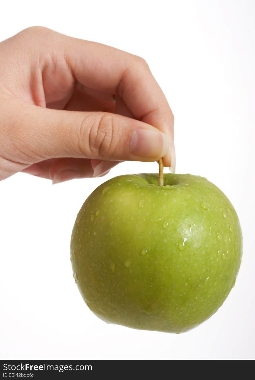 Holding a fresh green apple over a white background. Holding a fresh green apple over a white background