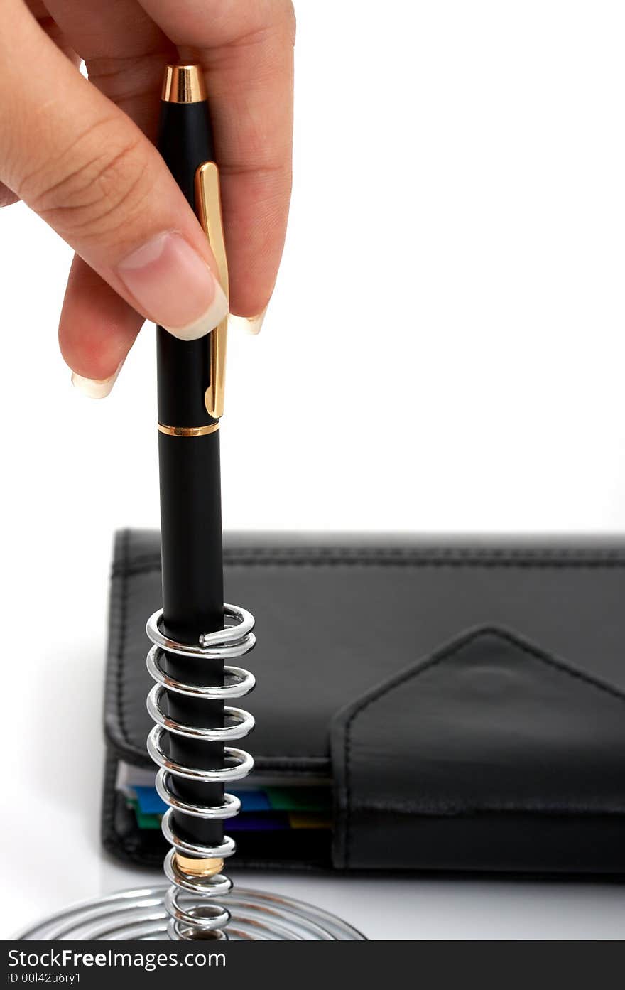 A pen and an organizer over a white background