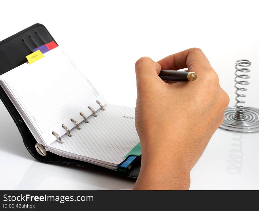 A pen and an organizer over a white background. A pen and an organizer over a white background