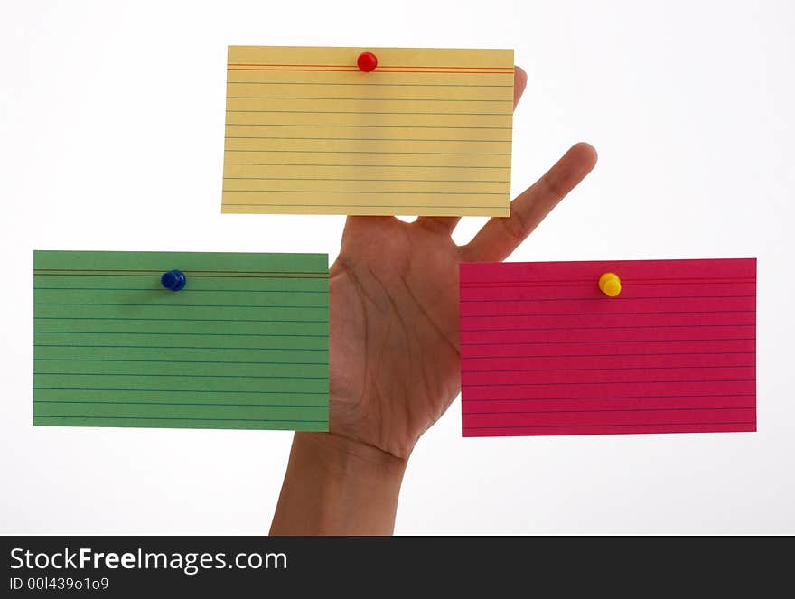 Three blank cards pinned on a hand