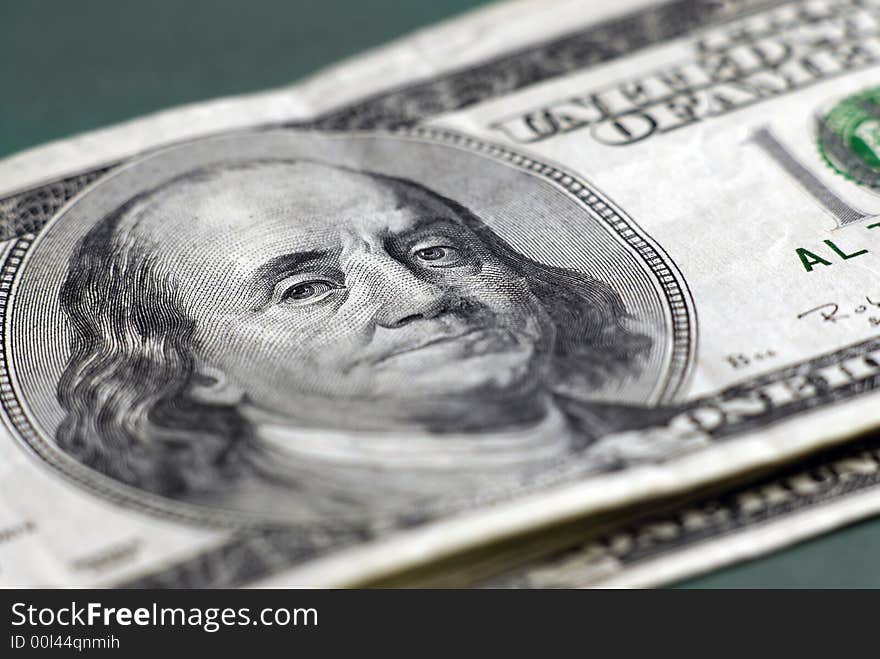 Closeup of hundred dollar bill isolated on background. Closeup of hundred dollar bill isolated on background