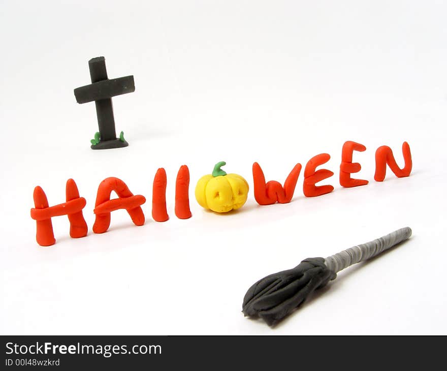 Halloween insrcription from the plasticine with cross and broom. Halloween insrcription from the plasticine with cross and broom