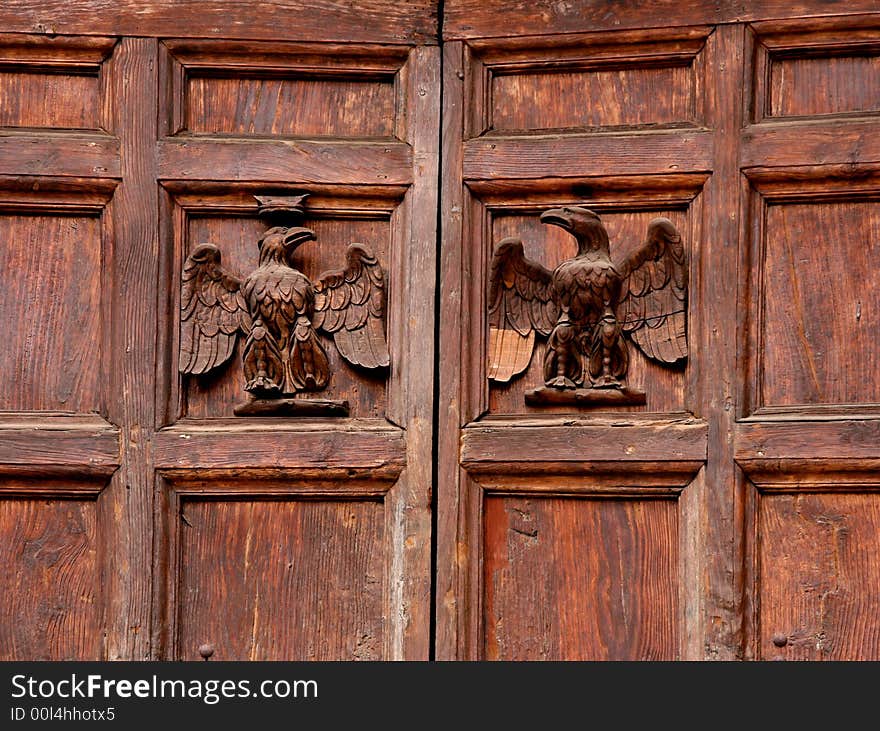 Two eagles carved in wood on an old door. Two eagles carved in wood on an old door