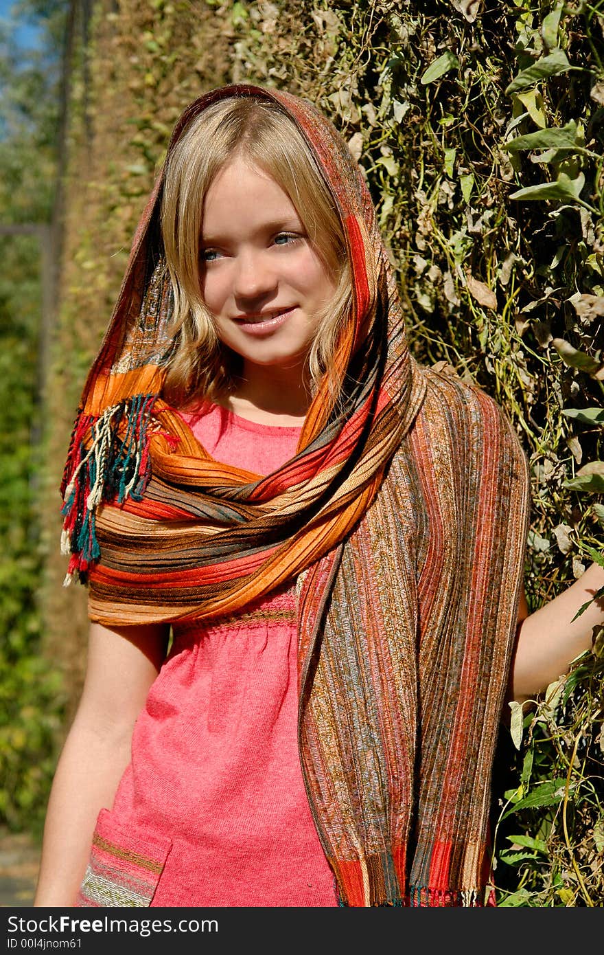 Beautiful girl in a scarf in the park