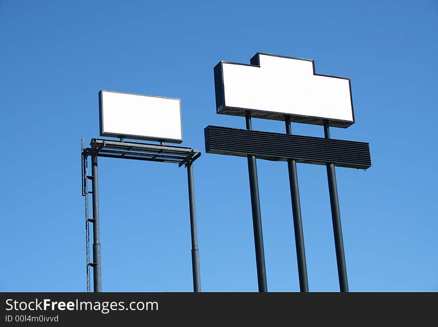 Two Blank Signs against blue sky