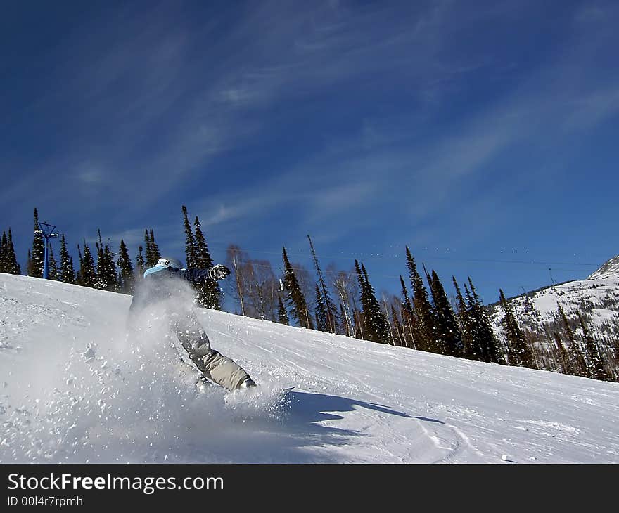 Fast moving snowboarder in slope. Fast moving snowboarder in slope