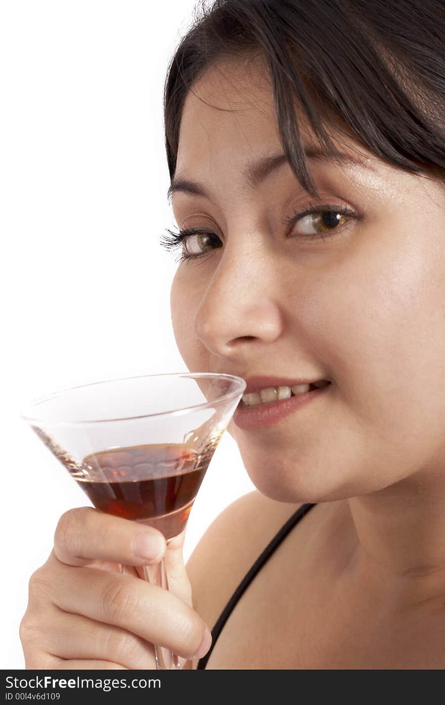 A young woman drinking a cocktail beverage over a white background. A young woman drinking a cocktail beverage over a white background