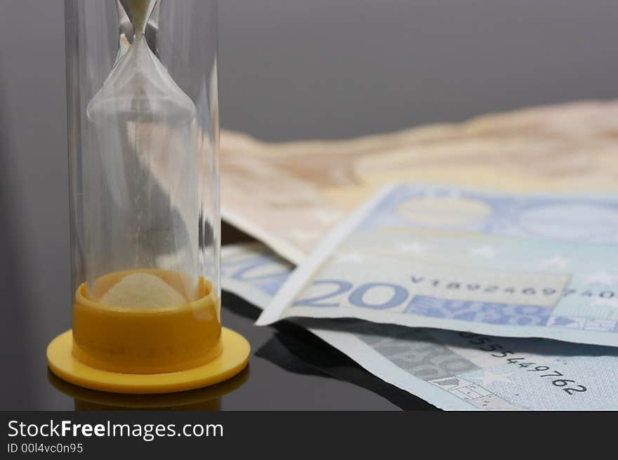 Hourglass and euro over a white background