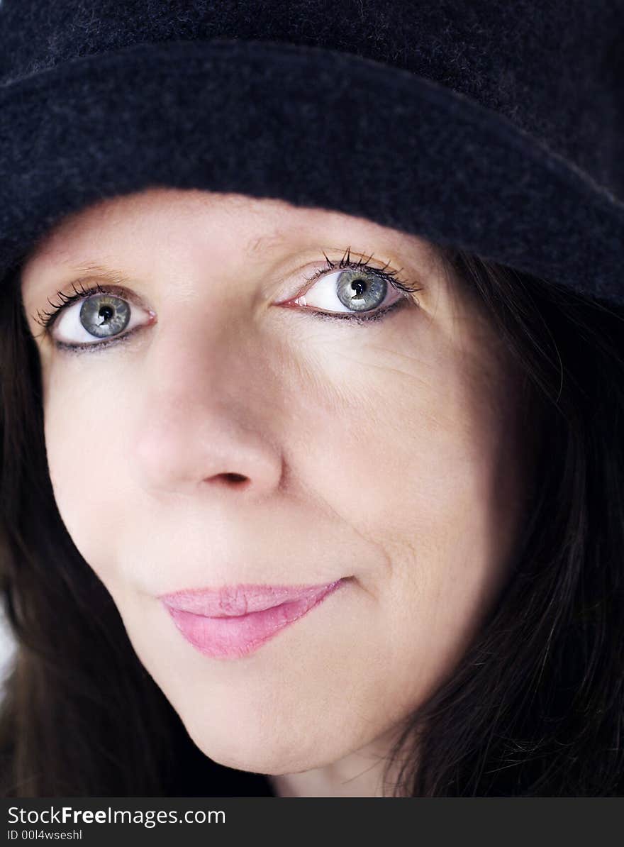 Middle-age woman portrait with black hat on, face close-up. Middle-age woman portrait with black hat on, face close-up