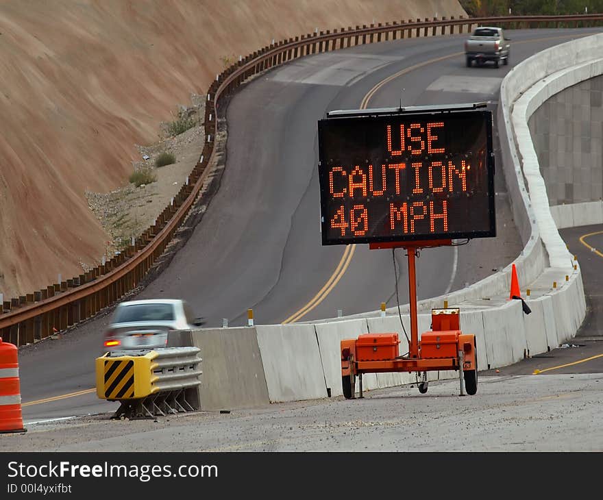 New road construction and detour with portable warning sign. New road construction and detour with portable warning sign