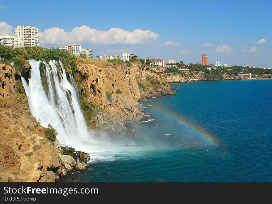 Falls of the river in sea on a background city