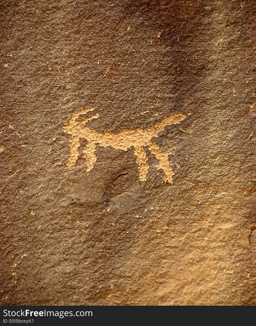 Ancient Anasazi petroglyphs etched into a rock wall