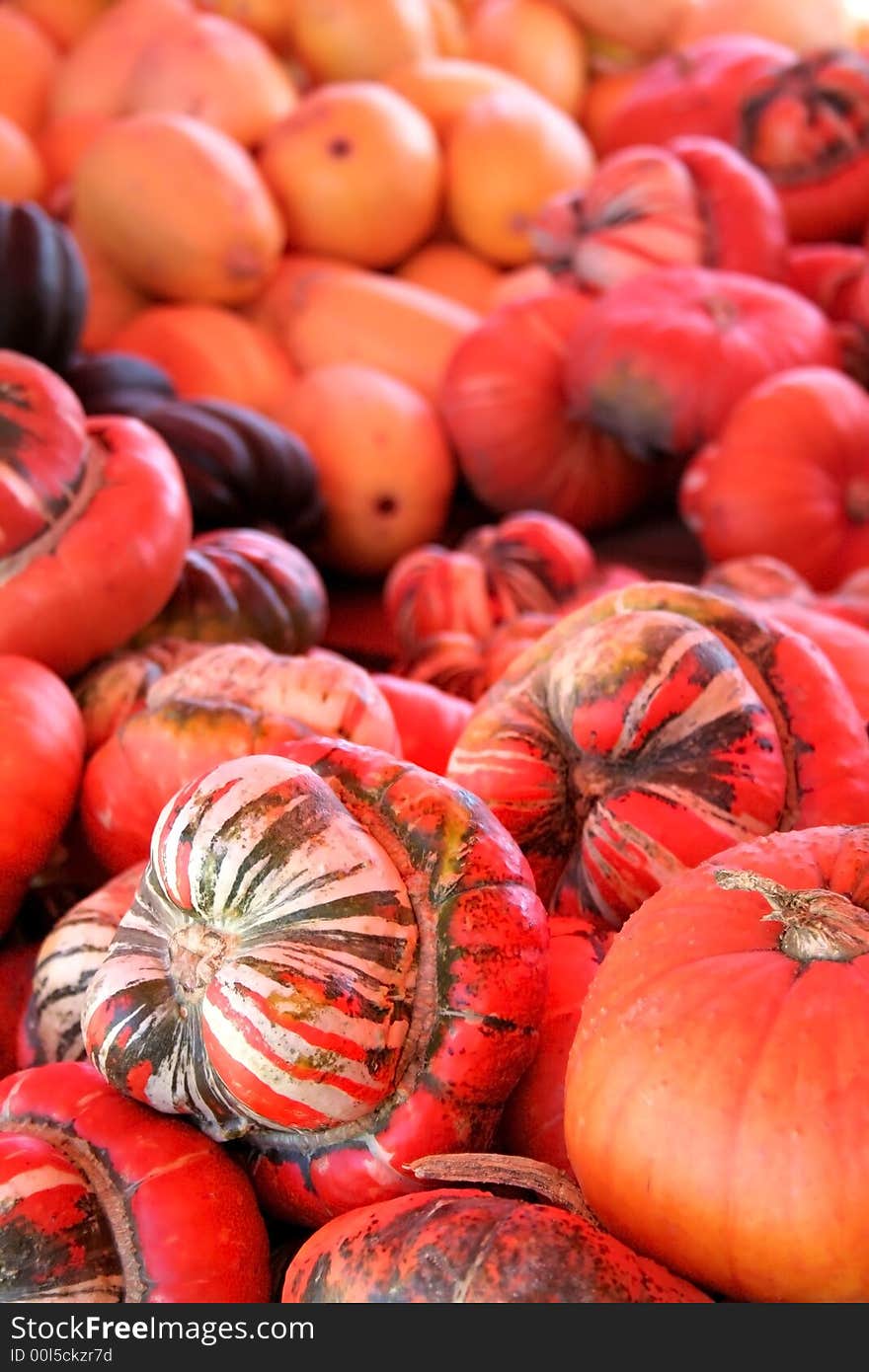 Pumpkins and fruits in a pile waiting to be sold. Pumpkins and fruits in a pile waiting to be sold