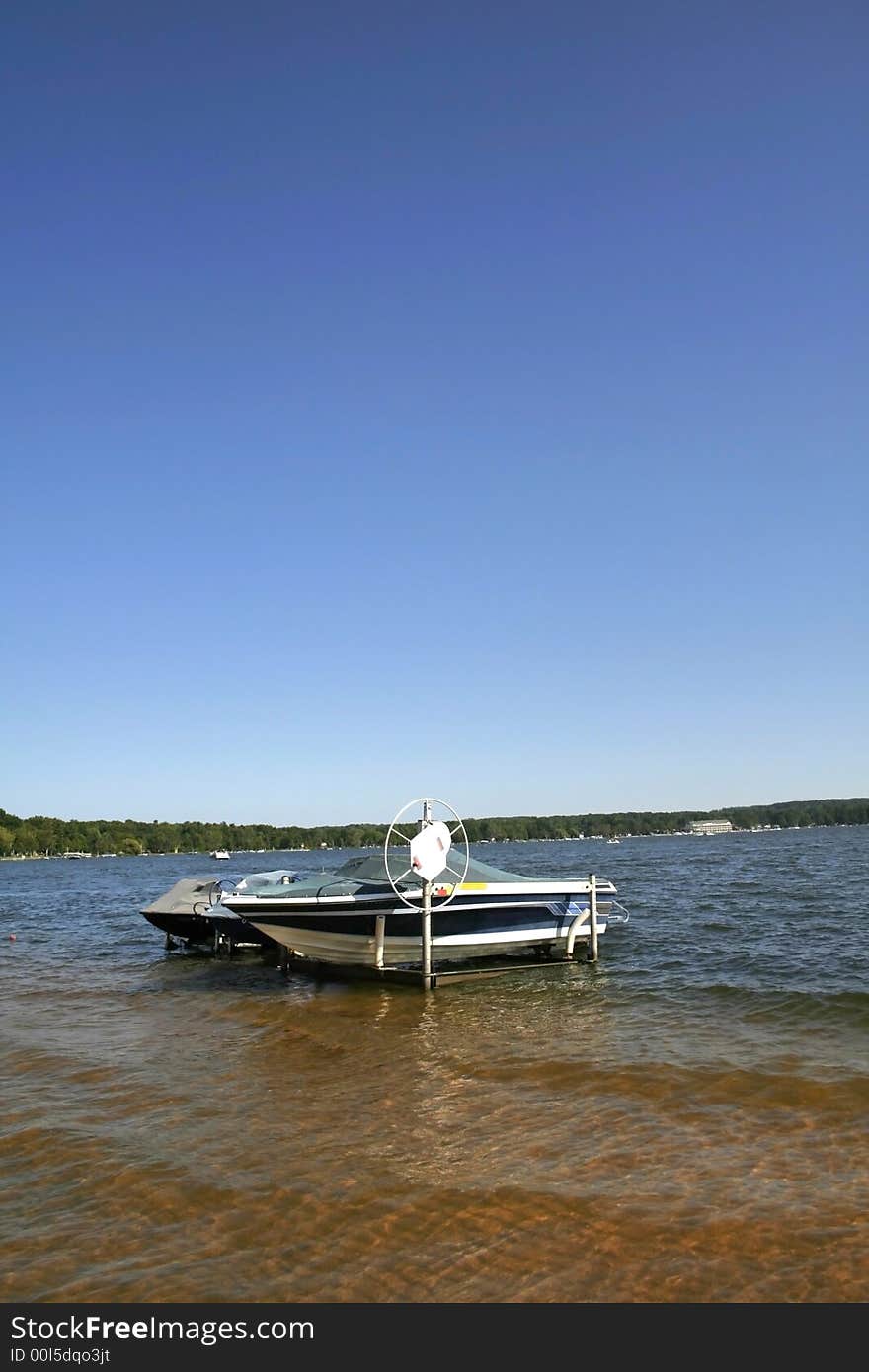 Motor boats anchored by the lake shore. Motor boats anchored by the lake shore