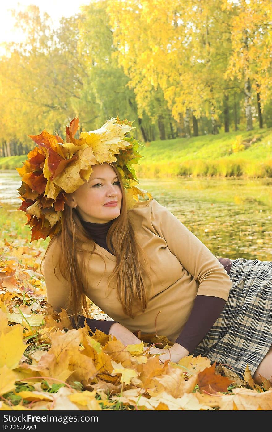 Portrait of the girl in a wreath from maple leaves