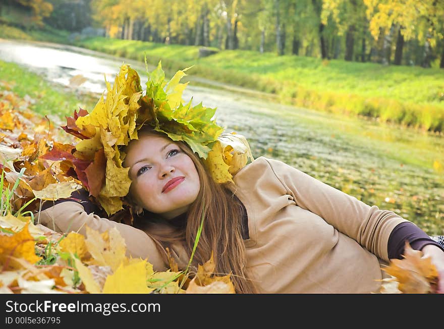 Portrait of the girl in a wreath from maple leaves