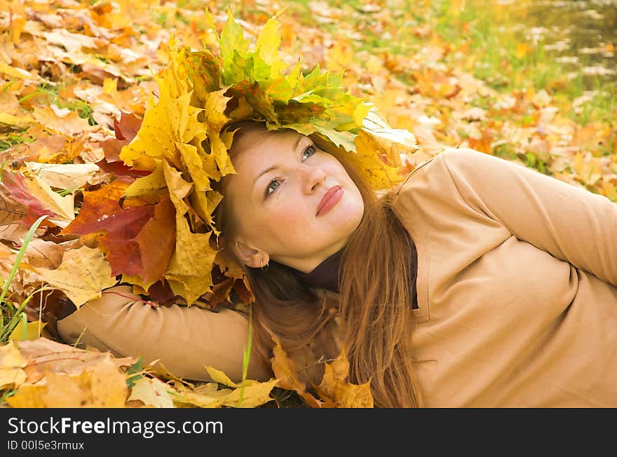 Portrait of the girl in a wreath from maple leaves